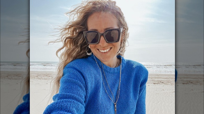 Woman in sweater on beach