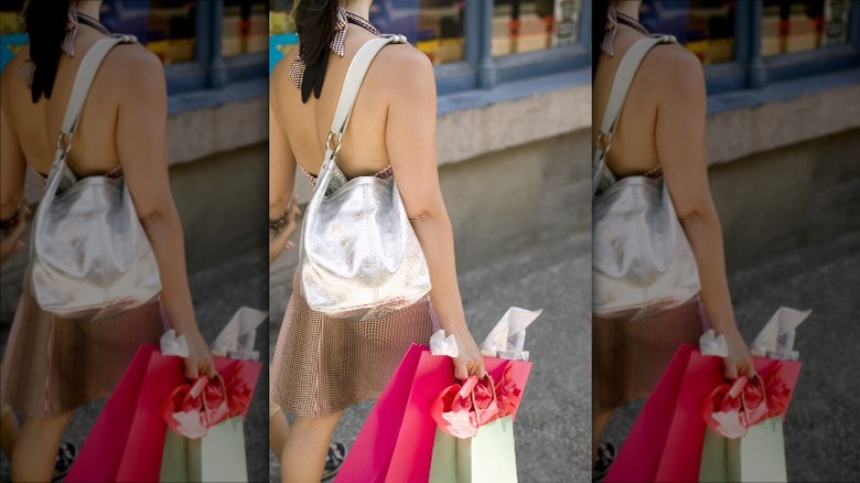 Woman carrying metallic silver handbag