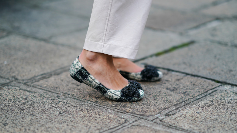 woman wearing checkered ballet flats