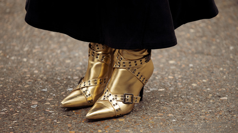 woman wearing gold boots