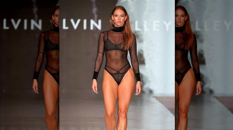  A model wearing mesh bathing suit