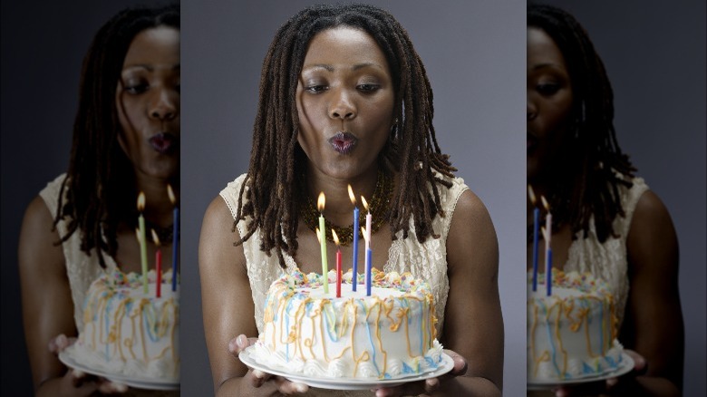 Woman blows out candles 