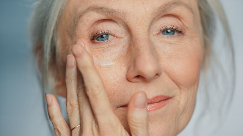 woman applying skincare cream