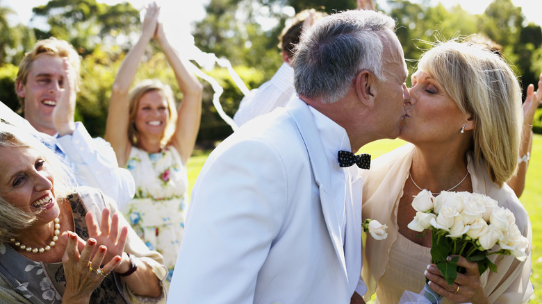 older couple kissing at wedding
