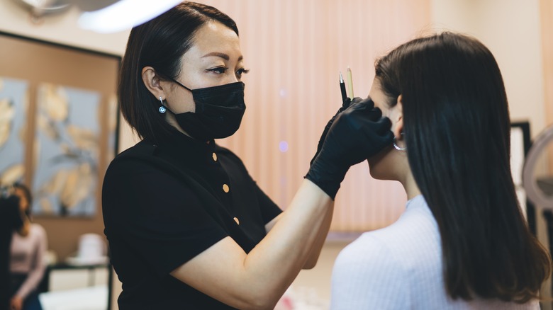 esthetician preparing microblading client