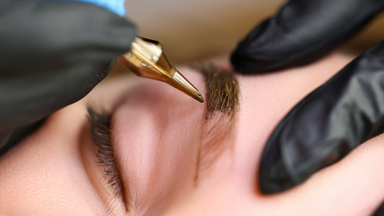 Woman being microbladed