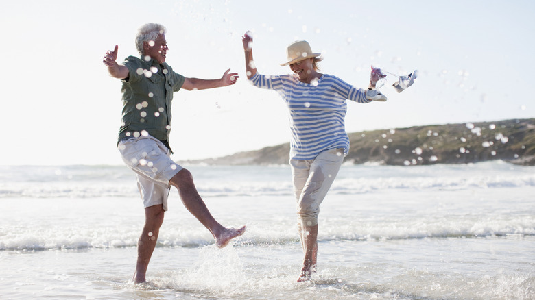 couple splashing on beach