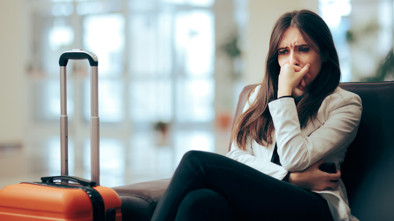 woman unhappy with suitcase