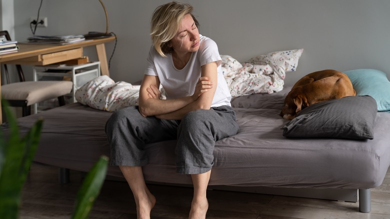 woman on edge of bed 