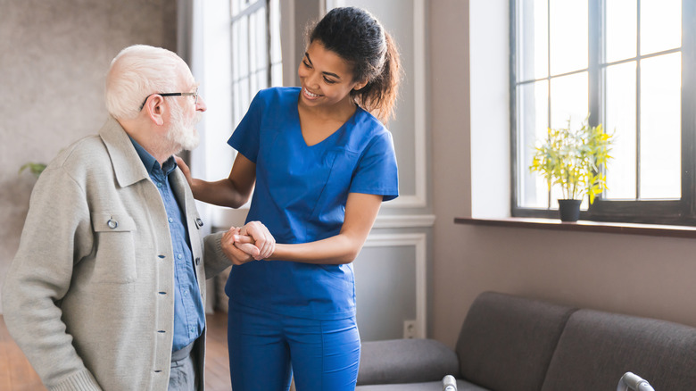 Nurse caring for elderly man