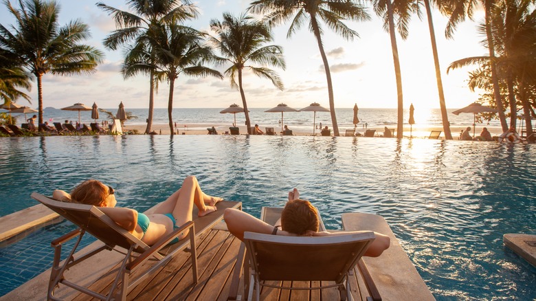 couple relaxing by pool