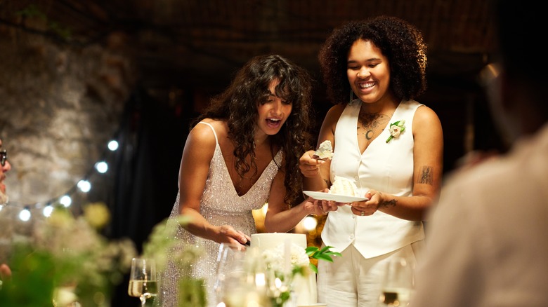 couple cutting cake together