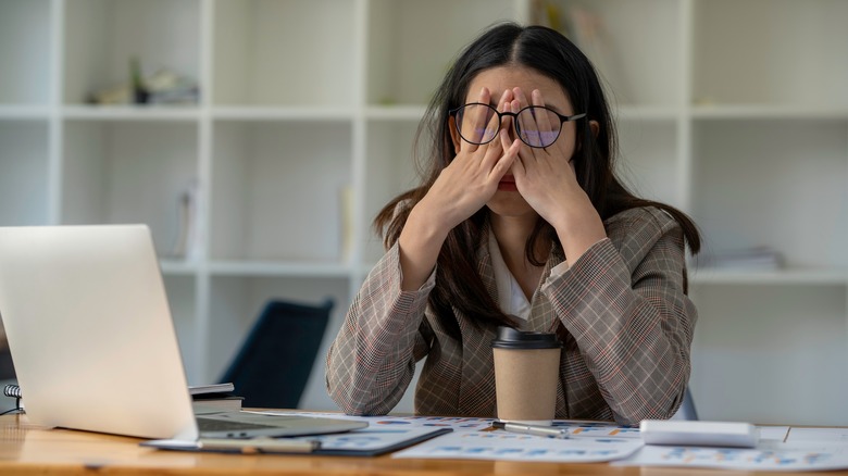 Tired woman working at home 