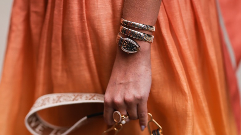 Woman wearing serpent shaped watch