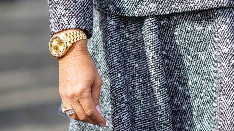 woman wearing yellow gold watch