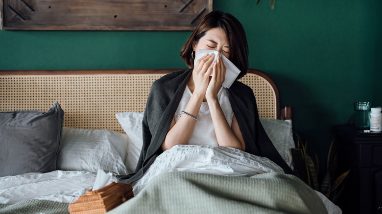 Woman with allergies in bed