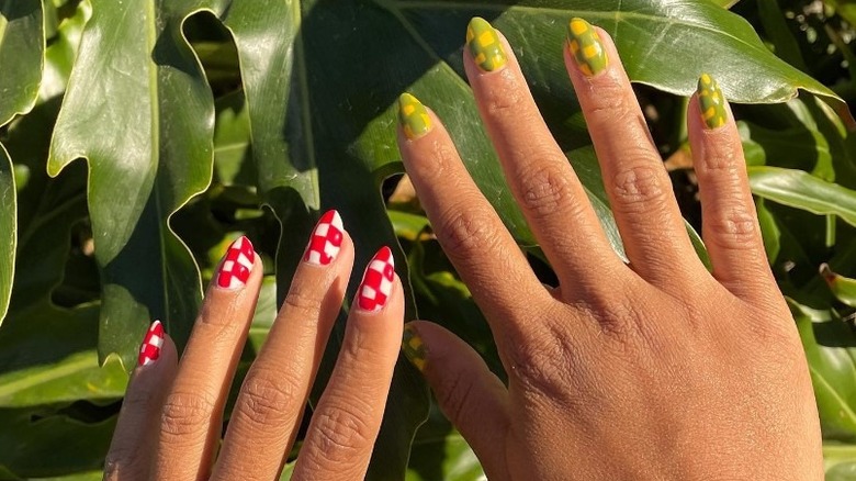 woman with mismatched checkerboard nails