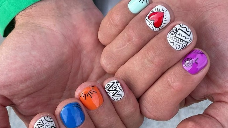 person with Keith Haring inspired nails