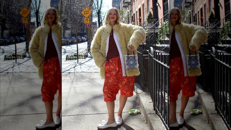 Influencer wearing a fur coat with shorts.
