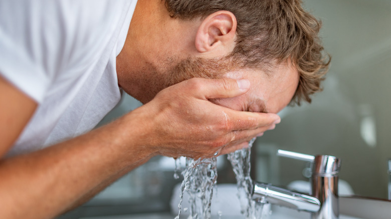 Man washing face.