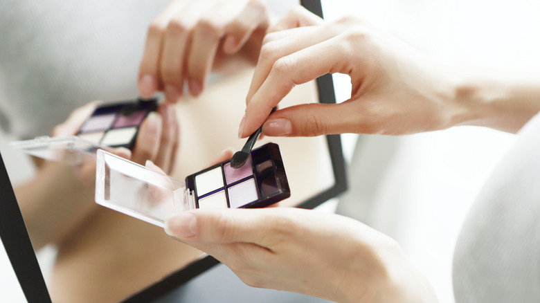 Woman holding an eyeshadow palette