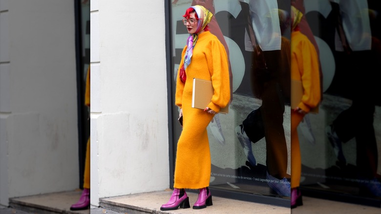 Woman in yellow maxi dress and pink boots