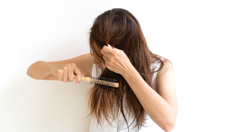 woman brushing messy wet hair