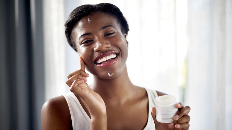 woman applying new skincare product