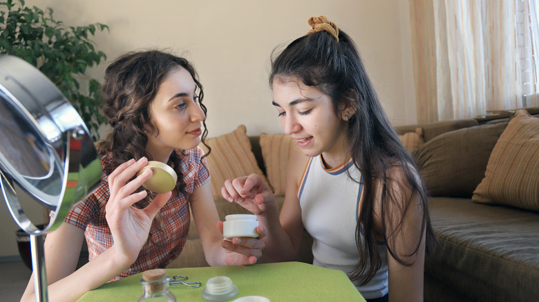 teenagers playing with skincare products