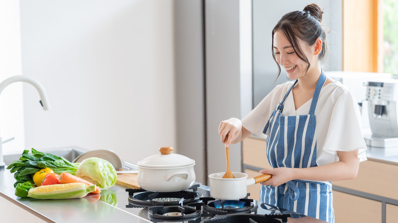 Woman cooks in kitchen