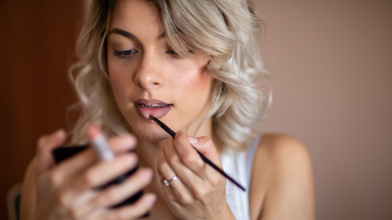 woman doing makeup