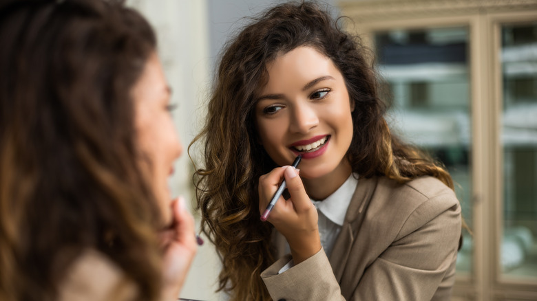 woman using lip liner