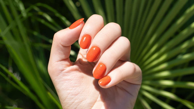 Orange gel manicure on nails