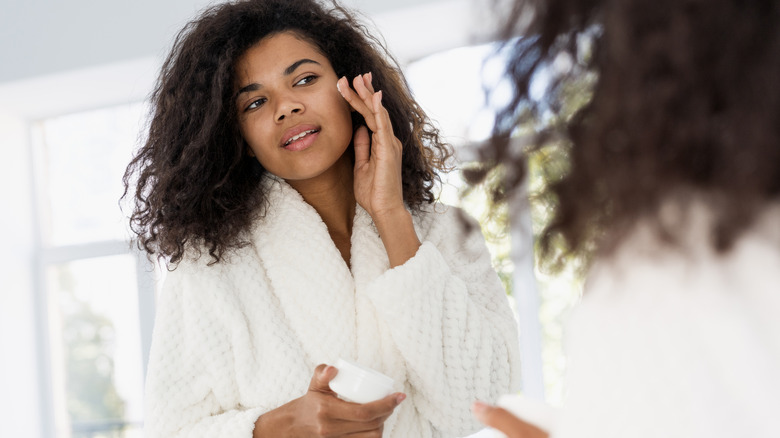 Woman applying face cream