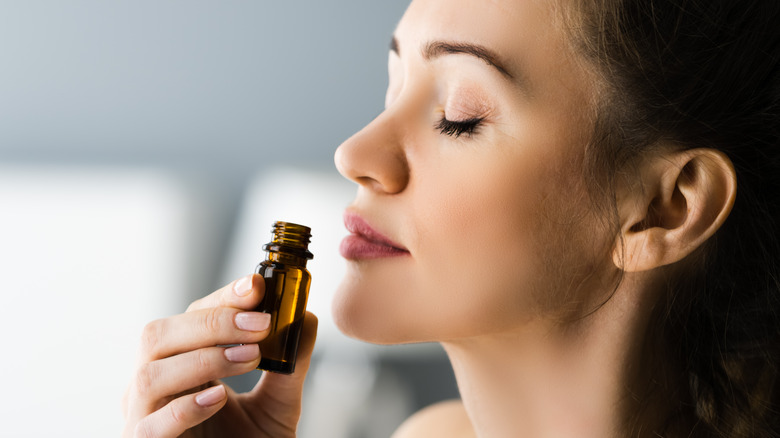 Woman smelling essential oil