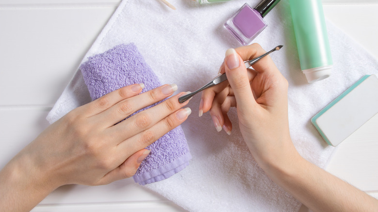 Woman pushing cuticle back