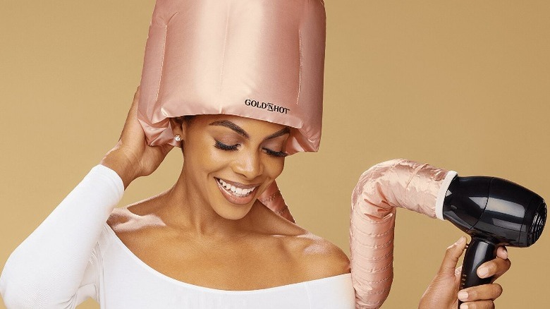 Woman using heating bonnet