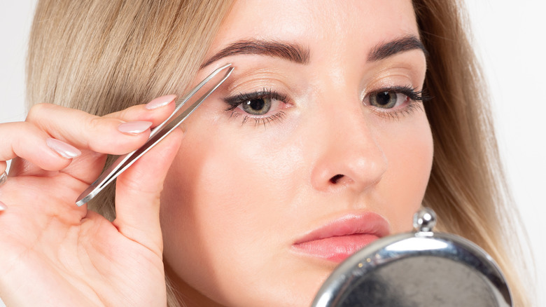 woman grooming eyebrows