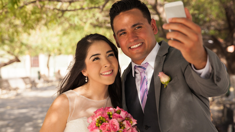 Bride, groom taking a selfie 