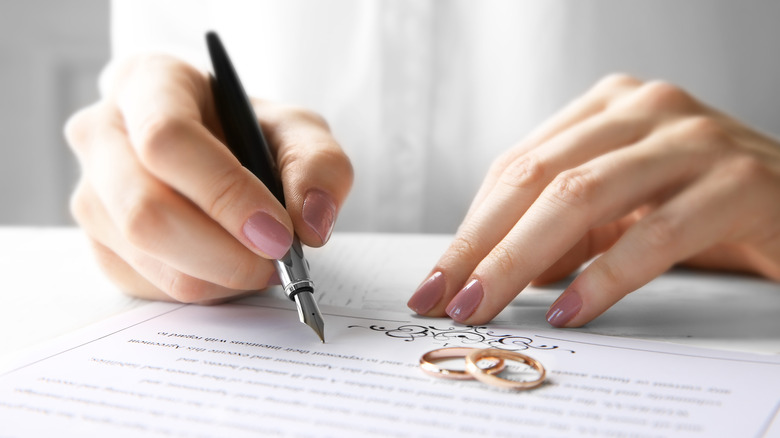 Woman signing wedding contract 