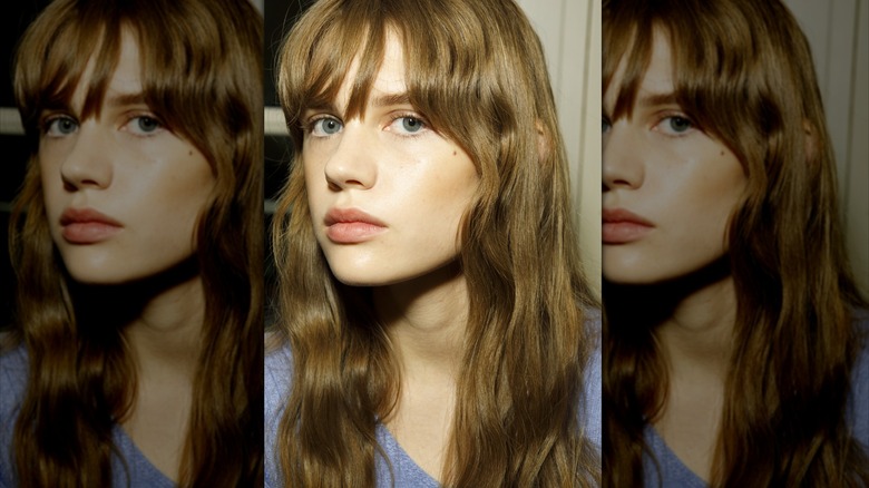 woman choosing hair color at salon