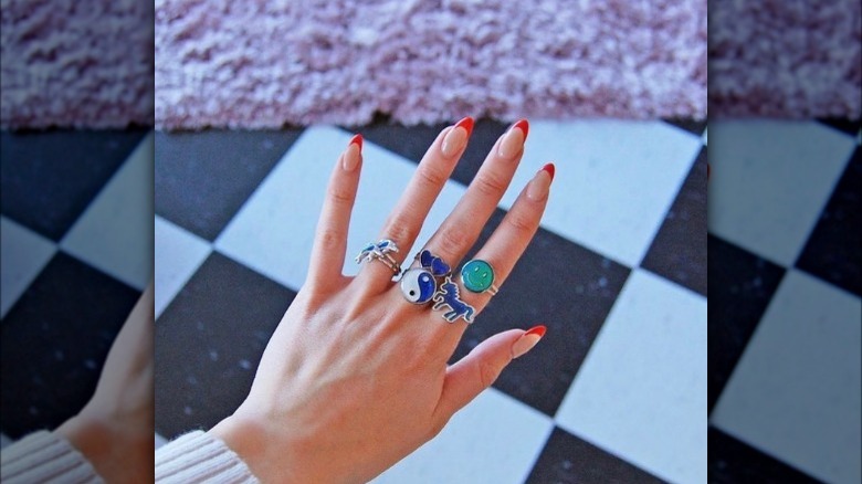 Multiple mood rings on woman's hand