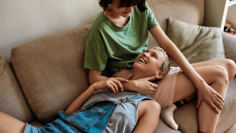 couple cuddling on sofa