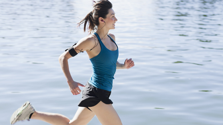 Woman running by the water