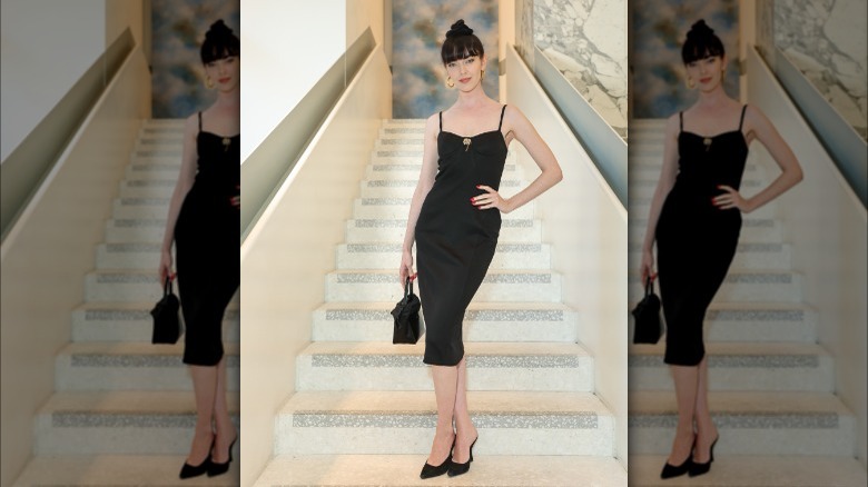 woman in black dress and black mules