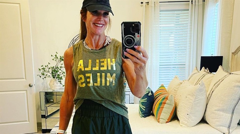 Woman takes selfie in muscle tank