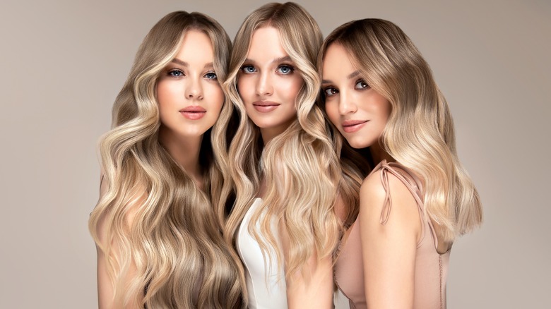 Three blond women posing