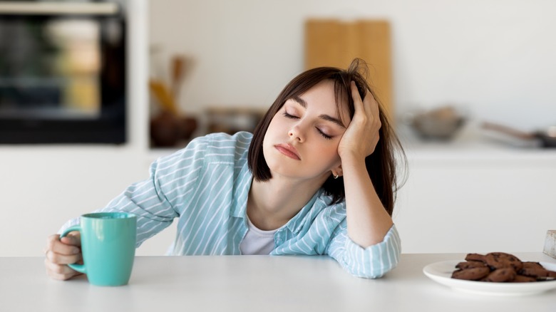 tired woman sitting at table