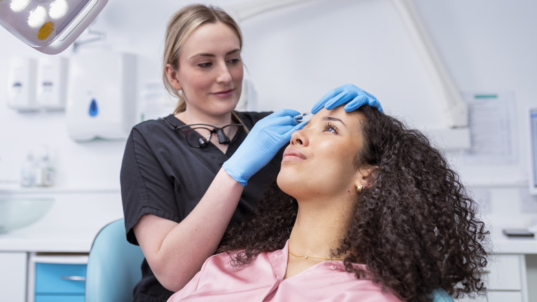 Nurse giving woman injectable