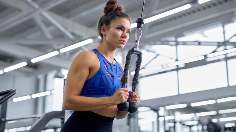 woman working triceps at gym